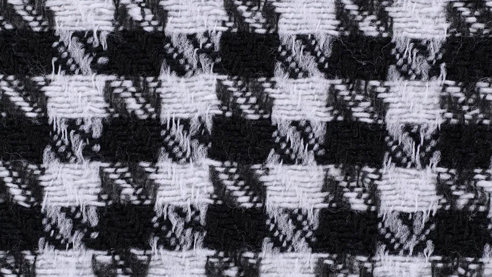 Close-up of a black and white houndstooth wool fabric